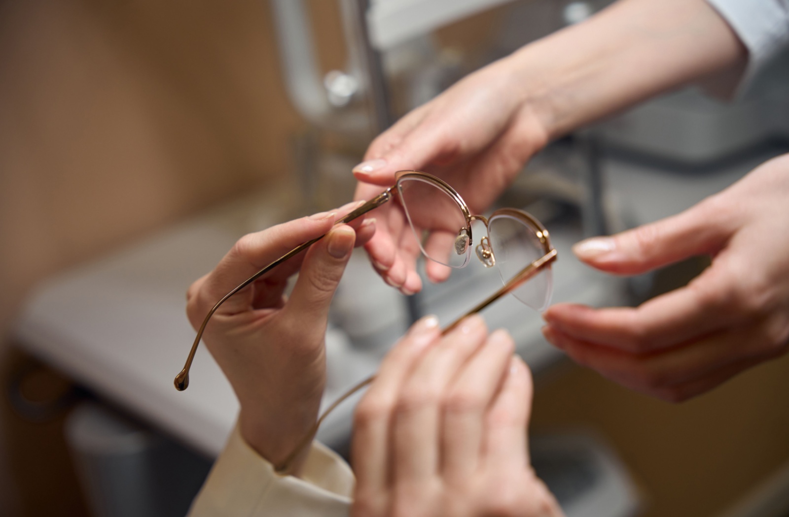 A close-up of a person recieving a pair of eyeglasses.