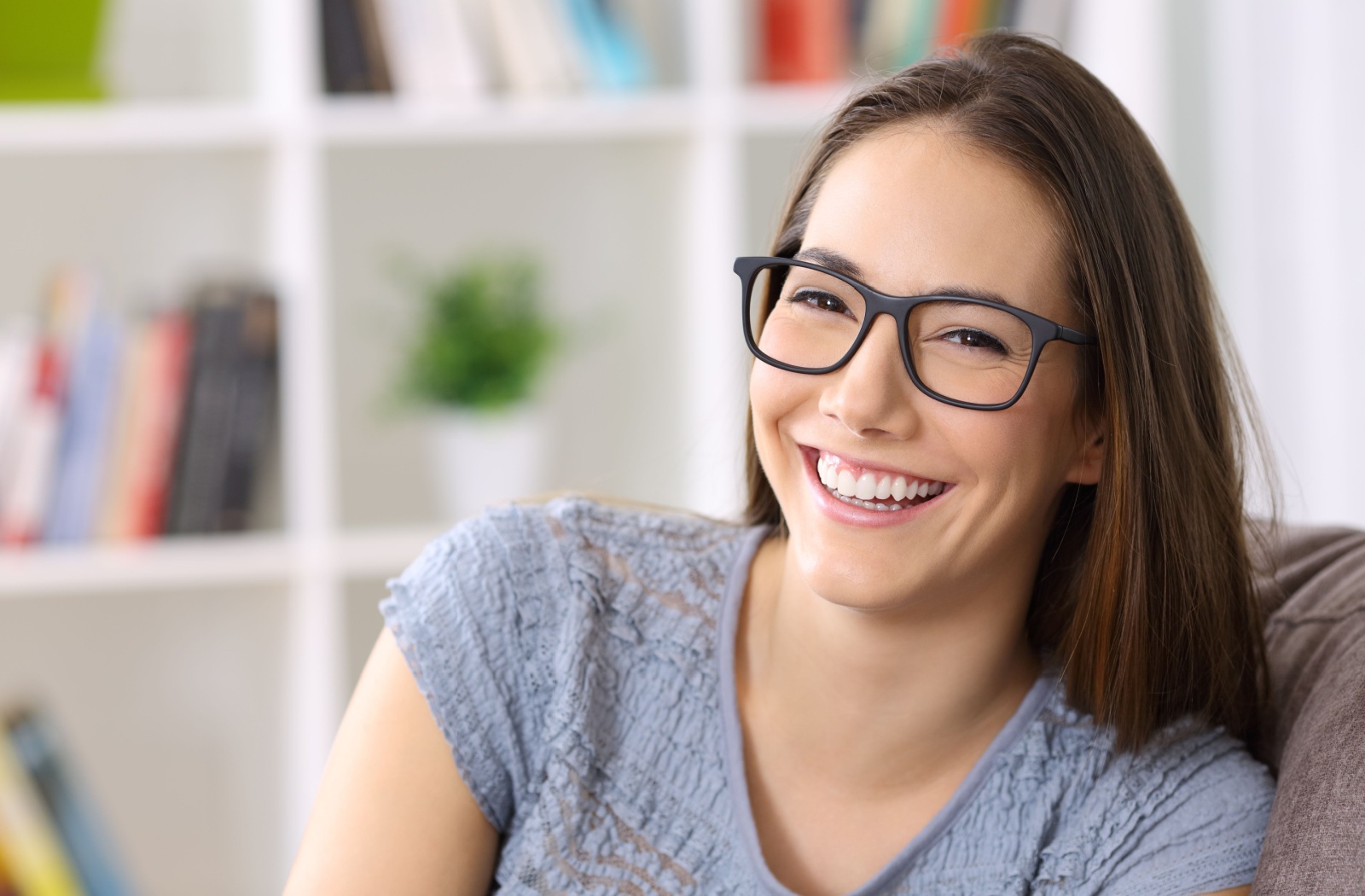A person wearing glasses and smiling