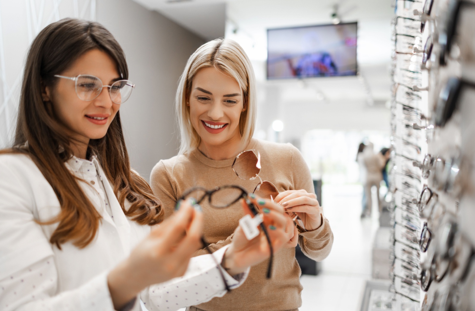 An optician helping someone find the perfect pair of glasses